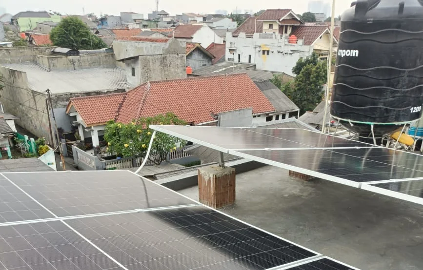 Panel surya pada rangka di atas atap dak rumah di Depok